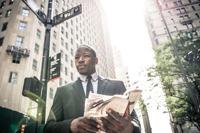 Low angle view of man and buildings in city