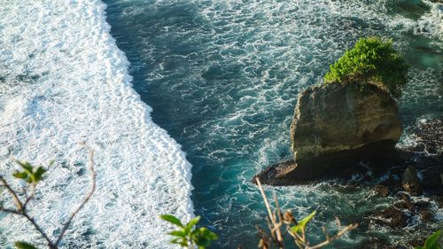 High angle view of rocks at sea shore