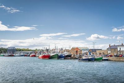 Boats in sea against sky