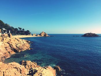 Scenic view of sea against clear blue sky