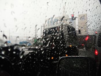 Cars seen through wet window in rainy season