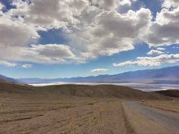 Scenic view of desert road against sky