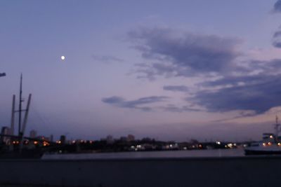 Illuminated cityscape against sky at night