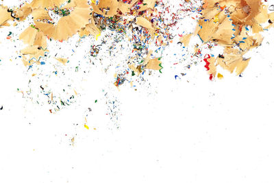 Low angle view of multi colored umbrellas against white background