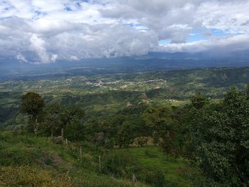 Scenic view of landscape against cloudy sky