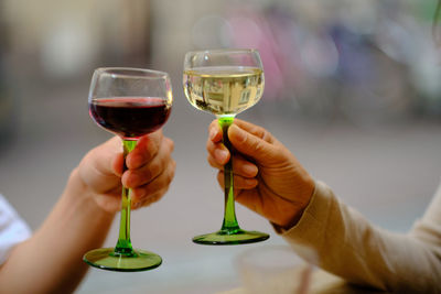 Close-up of hand holding glass of wine glasses