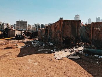 Abandoned buildings in city against clear sky