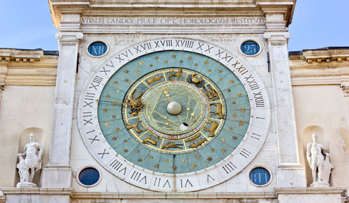 Low angle view of clock tower against building