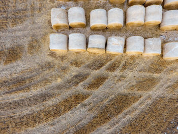 High angle view of hay bales on agricultural field