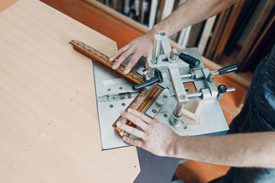 Cropped hands of man working on table