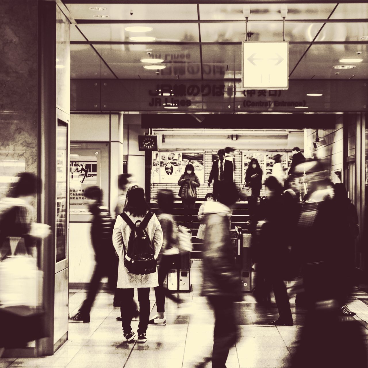 GROUP OF PEOPLE WALKING ON SUBWAY STATION