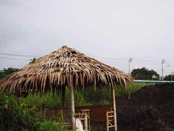 Traditional windmill on field against sky