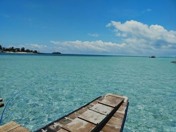 Scenic view of swimming pool by sea against sky