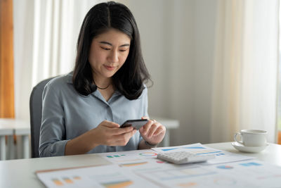 Portrait of young businesswoman working at office