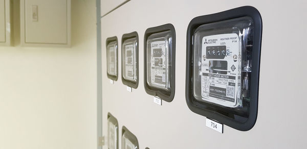 Low angle view of telephone booth on wall