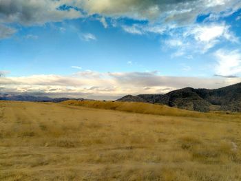 Scenic view of mountains against cloudy sky