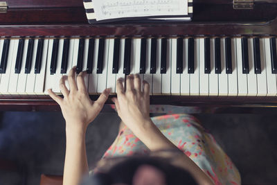 Close-up of hands playing piano