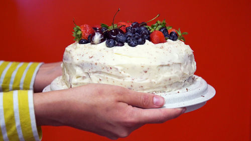 Human hand holding cake