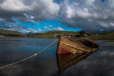 Boat moored on sea against sky