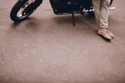 Legs of a man on a motorcycle. stylish middle aged man. hobby. middle age crisis.