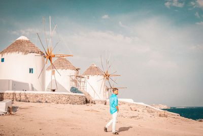 Full length of man standing at beach against sky