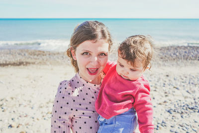 Portrait of mother and daughter at beach