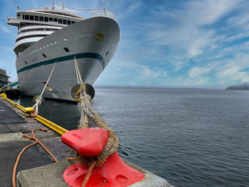 Boat moored in sea against sky