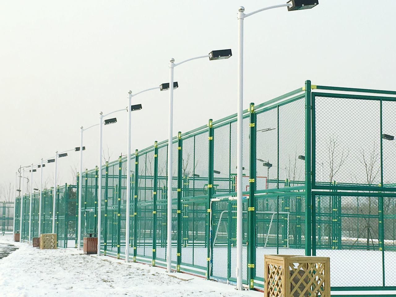 architecture, built structure, building exterior, clear sky, railing, sky, protection, fence, safety, day, outdoors, wall - building feature, street light, metal, security, in a row, window, no people, closed, low angle view