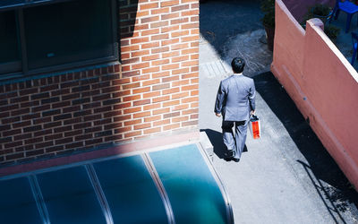 Rear view of man walking by water