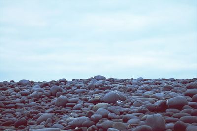 Close-up of pebbles against sky