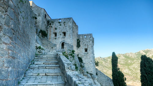 Old ruined fortress klis against blue sky