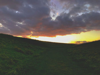 Scenic view of field against sky during sunset