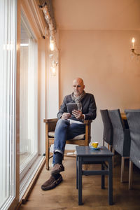 Young man sitting on sofa at home