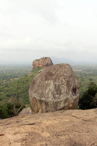 Rock formations on landscape against sky