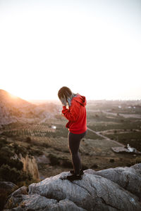 Rear view of man standing on rock
