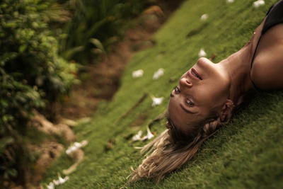 Portrait of woman lying down on land