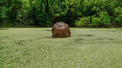 Portrait of mid adult woman in swamp