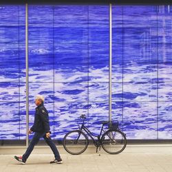 Full length of woman standing on bed