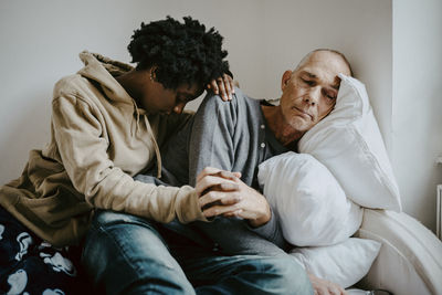 Midsection of couple sitting at home