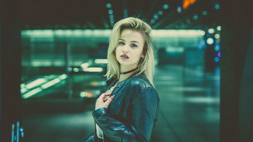 Portrait of young woman standing at night