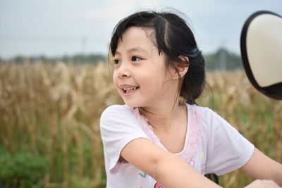 Portrait of smiling girl on field