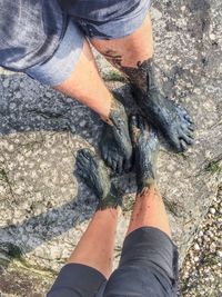 Low section of man standing on rock
