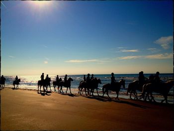 People on beach at sunset