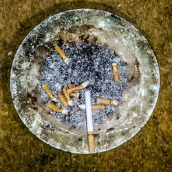 High angle view of cigarette smoking on table