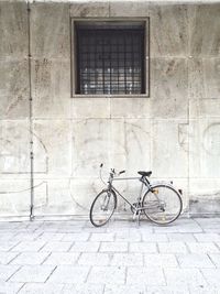 Bicycle parked against wall