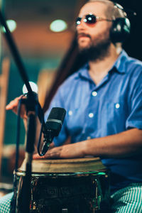 Close-up of man singing while playing musical instrument