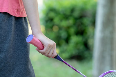 Cropped image of woman holding badminton racket