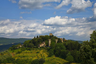 Panoramic view of green landscape and medieval village, chianti region tuscany 