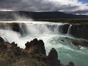 Goðafoss waterfall in iceland on a summer day with lots of clouds