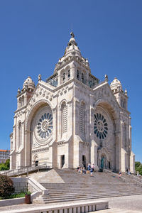 Low angle view of historical building against clear blue sky